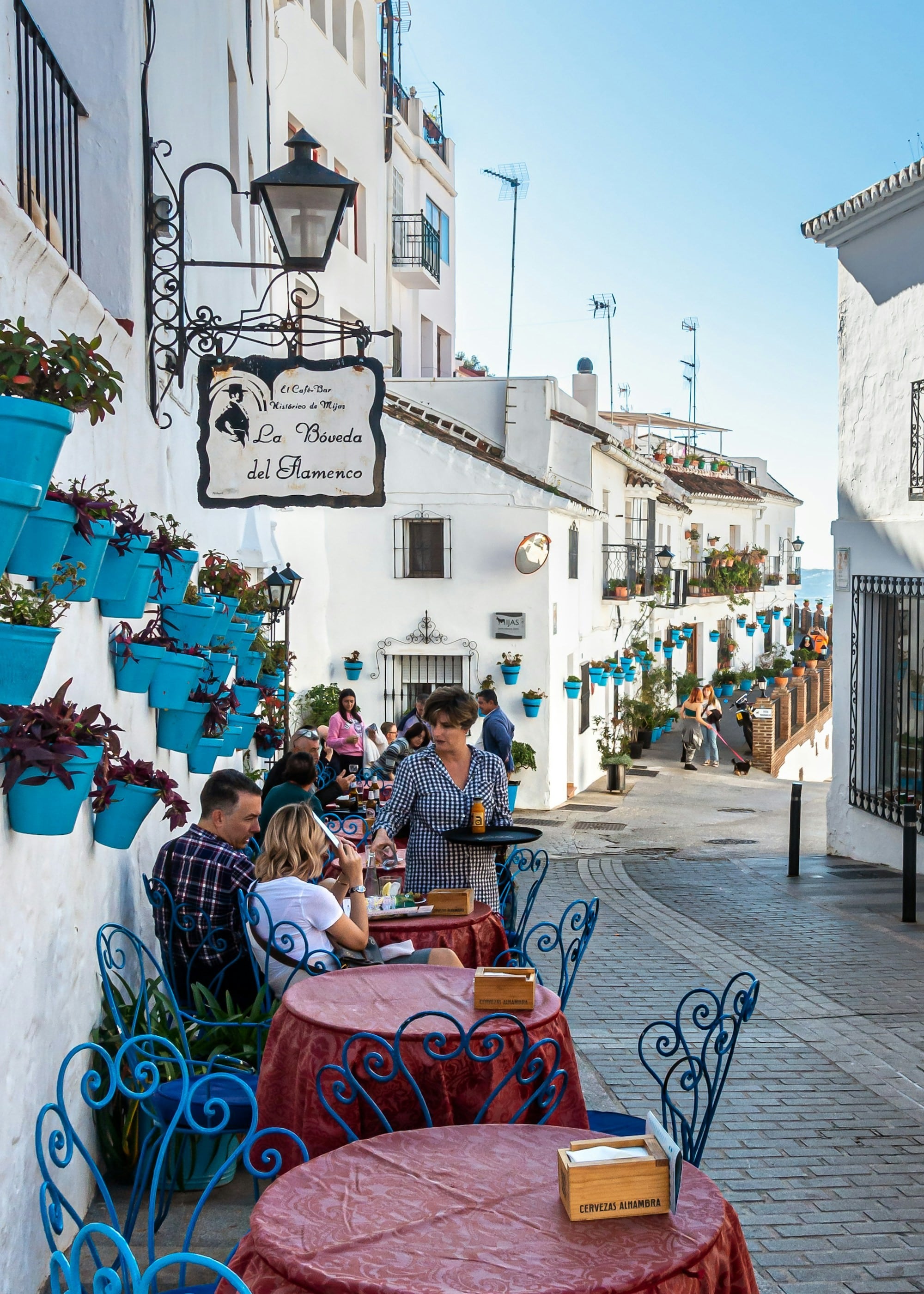 Cafe with patrons eating in europe. Experience London, Amsterdam, Paris, and Barcelona with D.R.E.W. Travel.