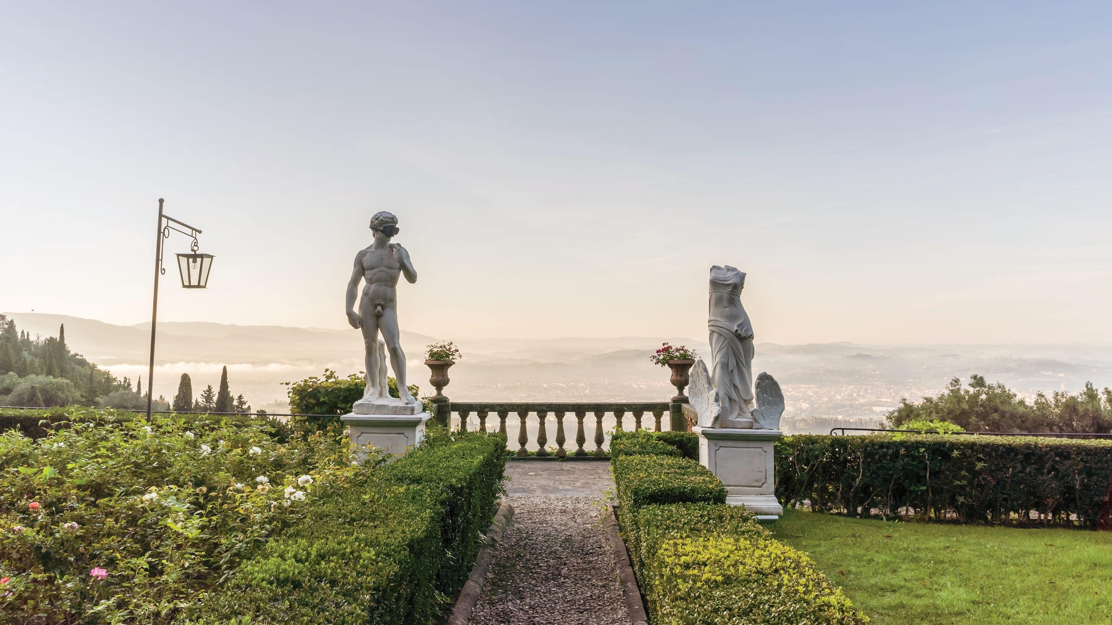 Male statue at the end of a walkway