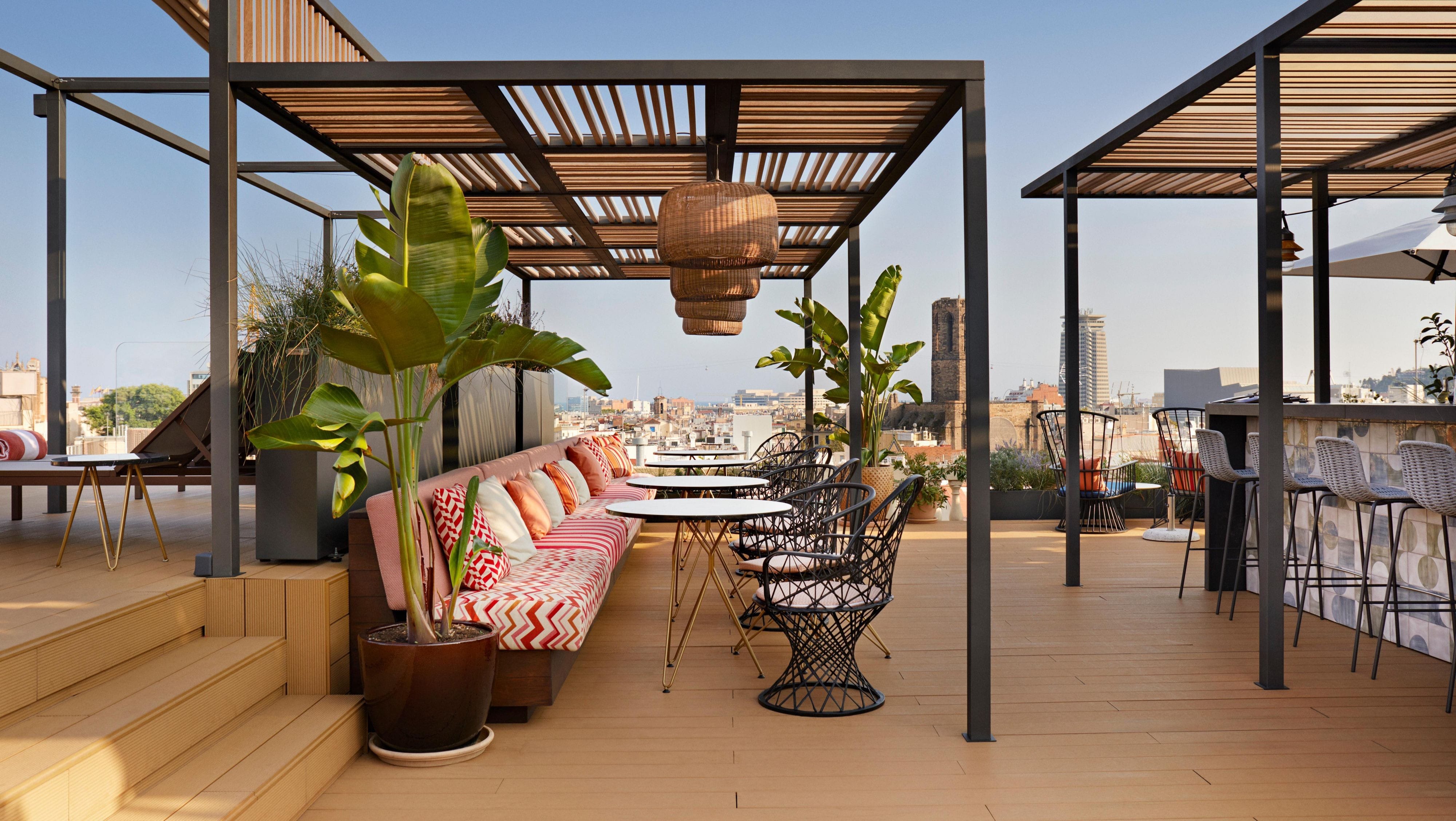 Outdoor seating area with a pergola chairs and tables.