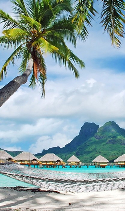 tiki bungalows over the water in Bora Bora